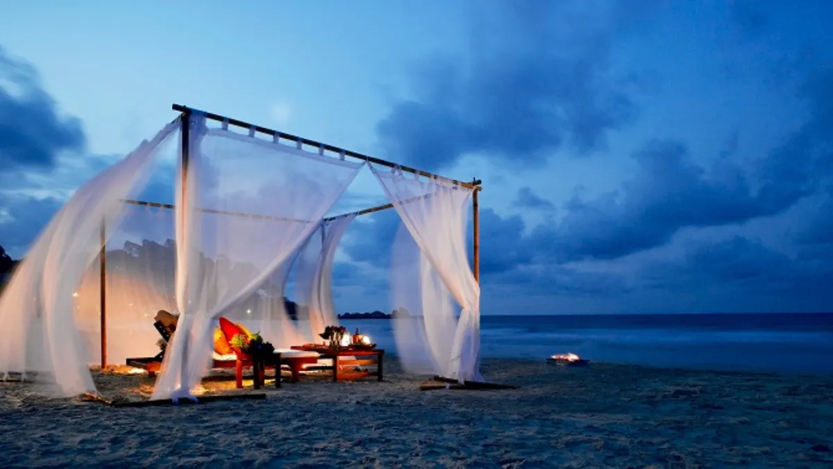 Laguna Bintan pristine beach loungers and palm trees
