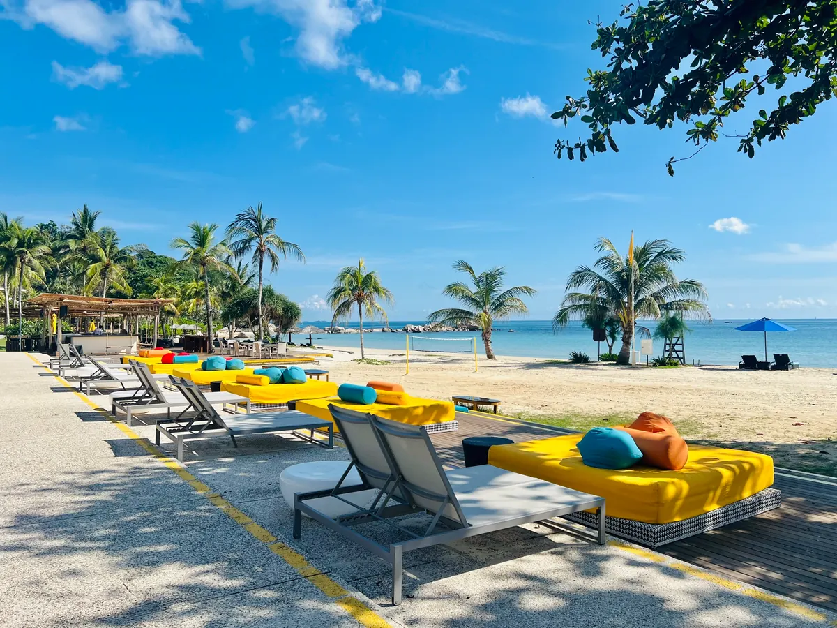 Cassia Bintan vibrant beachfront loungers and turquoise sea