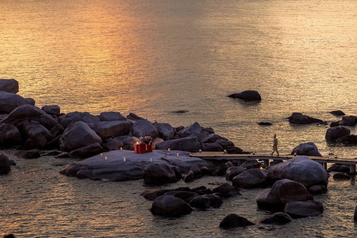 Dinner on rocky outcropping at sunset Laguna Bintan