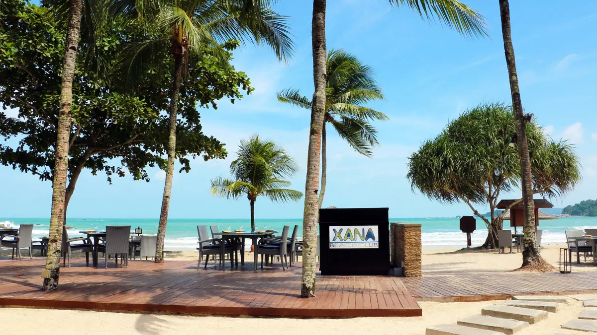 Cassia Bintan vibrant beachfront loungers and turquoise sea